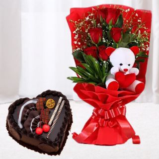 6 red roses bunch with 6 inch teddybear arranged in it along with 1 kg heart shape chocolate cake