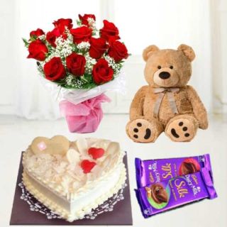 heart shape white forest cake with 1 feet height brown teddybear with 10 red roses bouquet with 2 dairy milk silk chocolates 