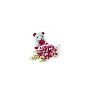 A beautiful hand bouquet of purple orchids with 6 inch teddy bear