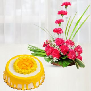 Basket arrangement of 15 pink carnations with mango cool cake 