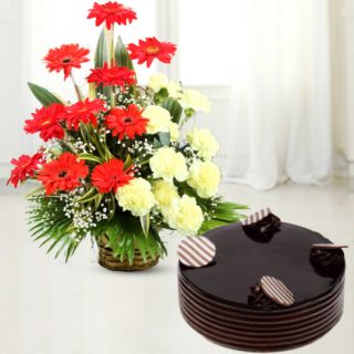 basket arrangement  of 20 carnations with gerberas with chocolate cake 