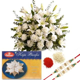 Basket Arrangement of 7 Lilies,10 white carnations,10 white roses, 1kg Kaju Burfee with one Rakhi's & Roli Chawa