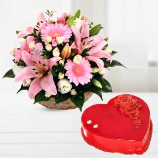Basket arrangement of lilies with gerberas with heart shape strawberry cool cake 