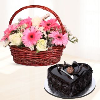 Basket Arrangement of pink gerberas with white roses with heart shape dark chocolate cake 