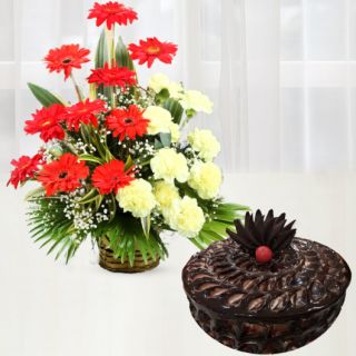 Basket arrangement of red gerberas with yellow carnations with chocolate fudge cake 