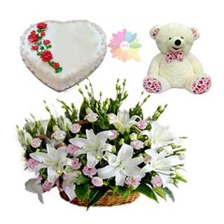 Basket arrangement of white lilies with pink roses with heart shape vanilla cake with 1 feet height teddy bear 