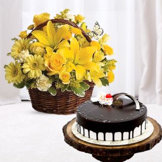 Basket arrangement of yellow gerberas, lilies, roses with choco vanilla cool cake 