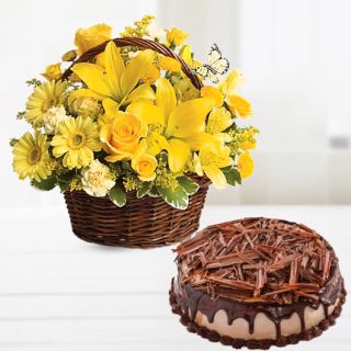 Basket arrangement of yellow lilies with yellow daisies with chocolate cheese cake 