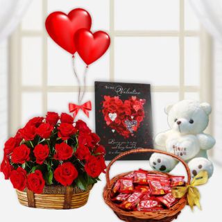 basket of 15 red roses with 1 feet height white teddybear, basket of kitkat chocolates, valentine day greeting card, pair of heart shape balloons 
