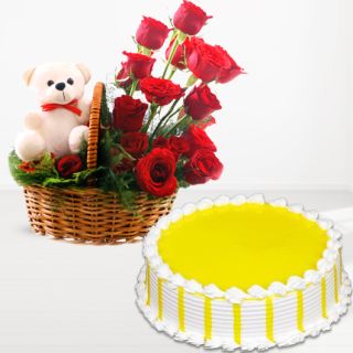 Basket of 15 red roses with teddy bear sitting in it with pineapple cake 