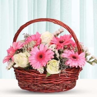 Basket of 7 pink gerberas with 6 white roses 