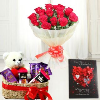 Basket of assorted chocolates with teddybear sitting in it, bunch of 10 red roses, valentine day greeting card 