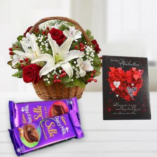Basket of red roses with white lilies, valentine Greeting card with set of 2 dairy milk silk chocolates 