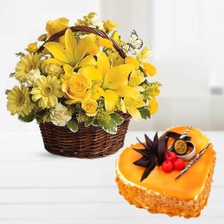 Basket of yellow gerberas with lilies and roses with heart shape mango cool cake 