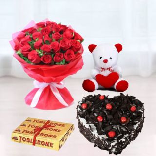 Bunch of 15 red roses, premium  black forest heart shape cake, 6 inch white teddy bear, with set of 3 toblerone chocolates 