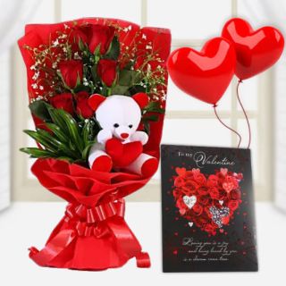 Bunch of 6 red roses is a special packing with a cute teddybear sitting in it with valetine day card and pair of heart shape balloons 