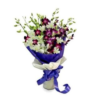 Exotic hand bouquet of lavender and white orchids mix together
