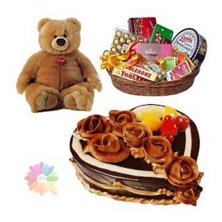 Chocolate hamper of premium assorted chocolates with 2 feet heigh teddy bear with chocolate heart shape cake with exotic fruits topping