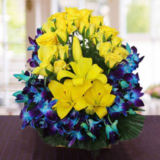 Exclusive basket arrangement of 10 blue orchids, 4 yellow lilies with 20 yellow roses 