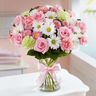 Exclusive Vase arrangement of pink roses , white gerberas , yellow carnations 