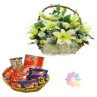 Exotic basket arrangement of lilies and roses with basket of assoted chocolates