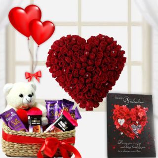 Heart shape arrangement of 50 red roses with basket of assorted chocolates with teddybear sitting in it ,valentine day card with pair of heart shape balloons 