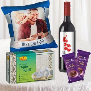 photo cushion with half kg kaju katli sweets , bottle of wine with 2 silk chocolates 