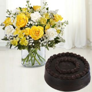 Vase arrangement of roses and carnations with chocolate cake 