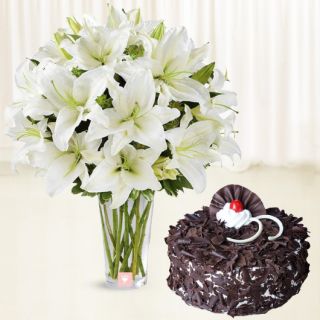Vase arrangement of 10 white lilies with black forest cake 