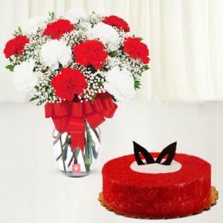 vase arrangement of 15 red and white carnations with red velvet cake 