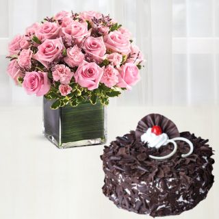 Vase arrangement of 30 pink roses with pink carnations with black forest cake 