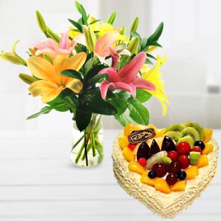 Vase arrangement of 5 mix colours lilies with heart shape mix fruit cake 