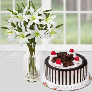 Vase arrangement of 5 white Asiatic lilies with black forest cool cake 