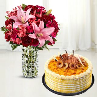 vase arrangement of lilies and carnations with honey cool cake 