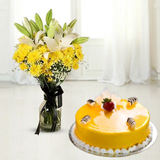 Vase arrangement of lilies and carnations with mango cool cake 