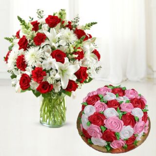 Vase arrangement of lilies , daisies, carnations with vanilla floral theme cake 