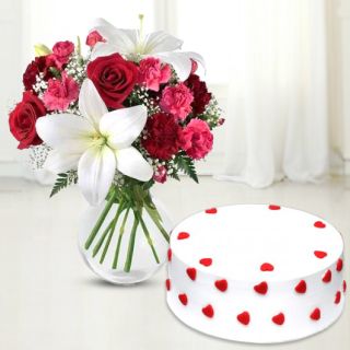 Vase arrangement of lilies, roses and carnations with vanilla cool cake 
