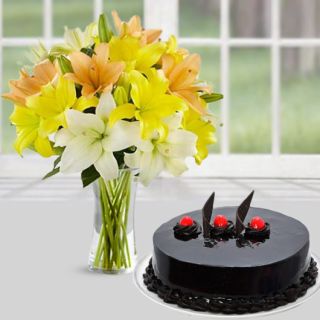 vase arrangement of mix colour lilies with chocolate cake 