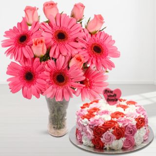 vase arrangement of pink gerberas with pink roses with vanilla floral theme cake 
