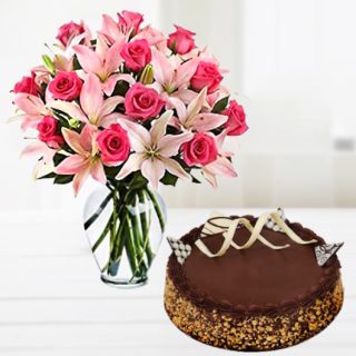 Vase arrangement of pink lilies with pink roses with chocolate almond cake 