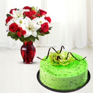 vase arrangement of red carnations with white lilies with kiwi cool cake 