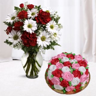 Vase arrangement of white gerberas and red carnations with vanilla floral theme cake 