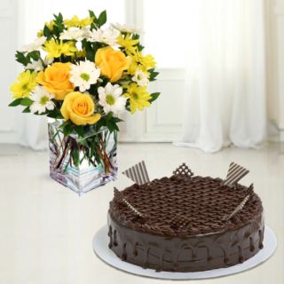 Vase arrangement of yellow roses with white daisy with chocolate cake 