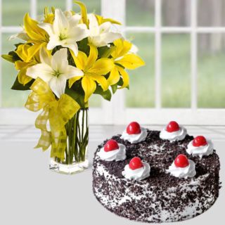vase arrangement of yellow white lilies with black forest cake 