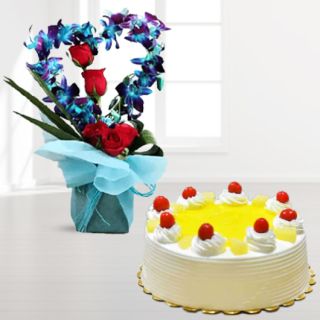 Vase arrangement of 8 blue orchids with 3 red roses with pineapple cool cake 