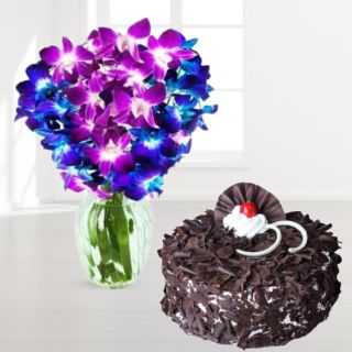 Vase arrangement of blue and purple orchids with black forest cake 